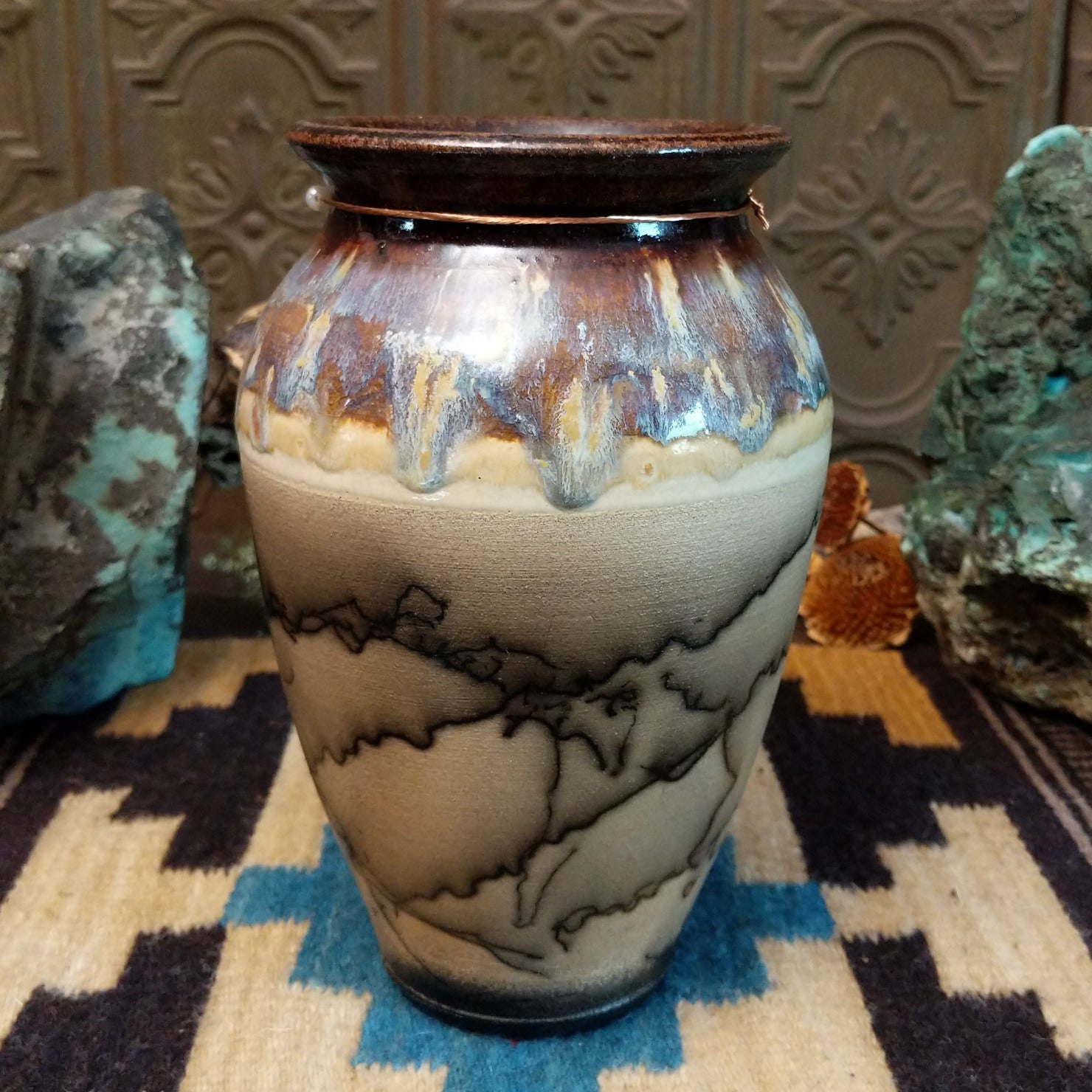 Ceramic, horsehair, and copper pottery piece.