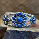 Sterling silver cuff bracelet with lapis set in bezels and twisted rope accents.