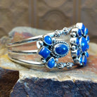 Sterling silver cuff bracelet with lapis set in bezels and twisted rope accents.