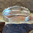 Sterling silver cuff bracelet with lapis set in bezels and twisted rope accents.