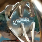 Close-up of the artisan's stamped signature.