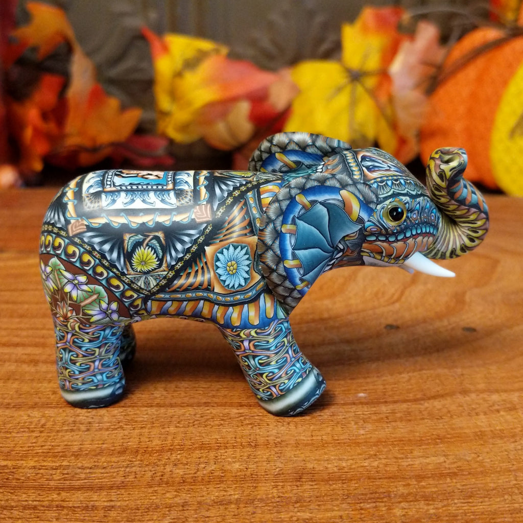 Polymer clay used to create an elephant with colorful geometric and floral designs.