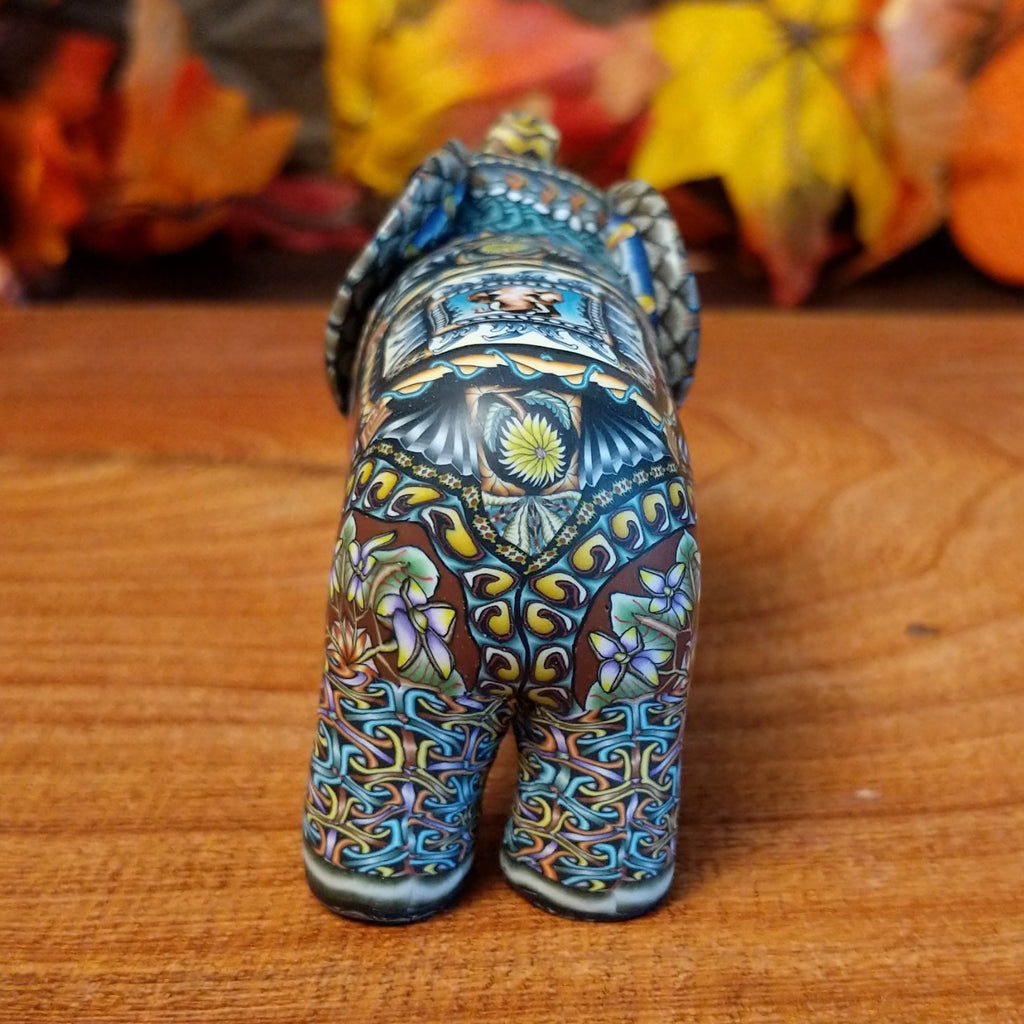 Polymer clay used to create an elephant with colorful geometric and floral designs.