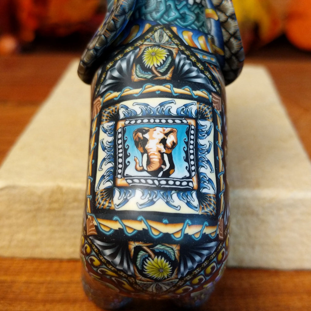 A close-up of the detailed elephant face on the figures back.