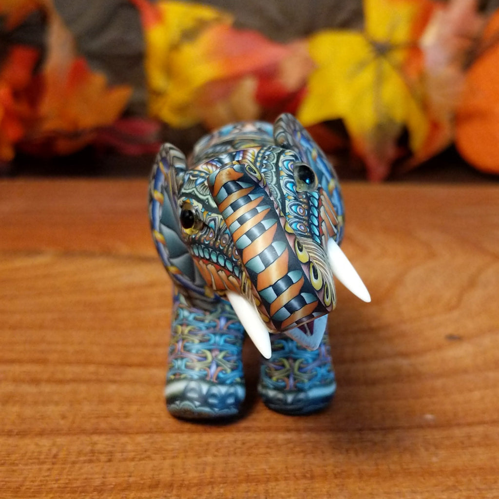 Polymer clay used to create an elephant with colorful geometric and floral designs.