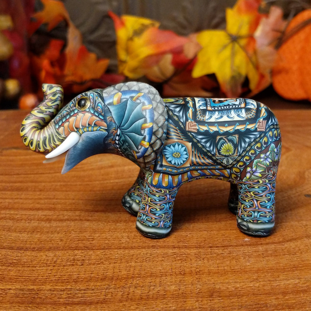 Polymer clay used to create an elephant with colorful geometric and floral designs.