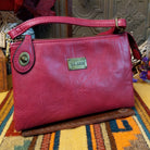 Ella Handbag by Liz Soto featuring a compact structured silhouette, textured exterior, dual handles, turn-lock accent, top zip closure, and rectangular Liz Soto logo plaque.