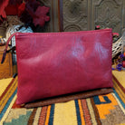 Ella Handbag by Liz Soto featuring a compact structured silhouette, textured exterior, dual handles, turn-lock accent, top zip closure, and rectangular Liz Soto logo plaque; back view.