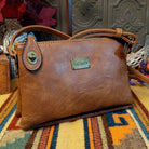 Ella Handbag by Liz Soto featuring a compact structured silhouette, textured exterior, dual handles, turn-lock accent, top zip closure, and rectangular Liz Soto logo plaque.