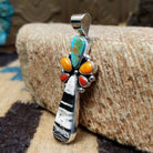 Sterling silver pendant with multiple stones set in various shaped bezels.