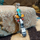 Sterling silver pendant with multiple stones set in various shaped bezels.