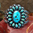 Sterling silver cuff bracelet with Kingman turquoise set in oval bezels, framed by twisted rope and dotted accents.