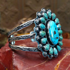 Sterling silver cuff bracelet with Kingman turquoise set in oval bezels, framed by twisted rope and dotted accents.