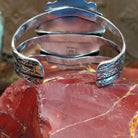 Sterling silver cuff bracelet with Kingman turquoise set in oval bezels, framed by twisted rope and dotted accents.