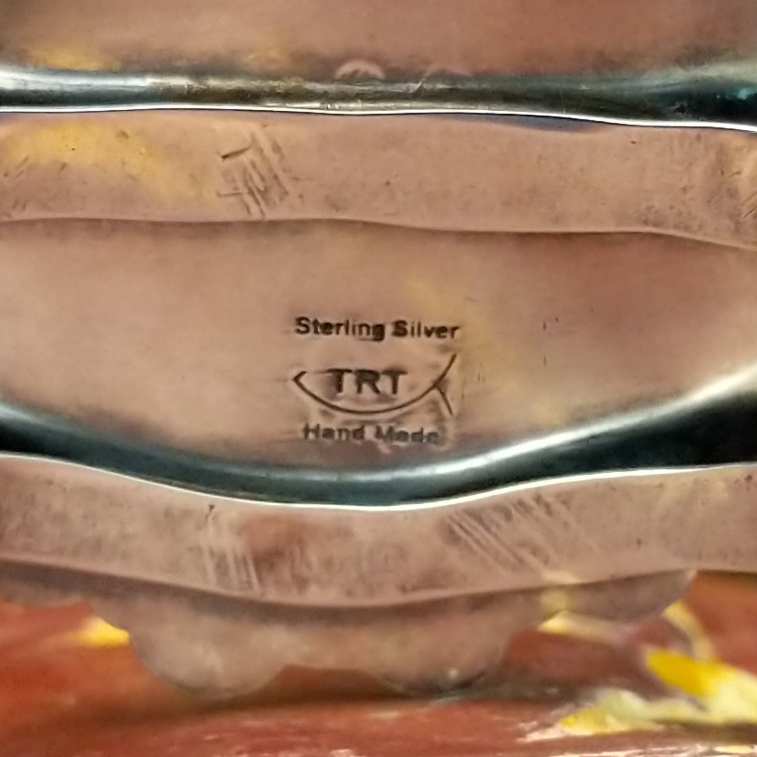 Close-up of the artisan's stamped signature.