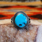 Sterling silver ring with Sleeping Beauty turquoise set in the round bezel, framed by the lined setting.