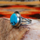 Sterling silver ring with Sleeping Beauty turquoise set in the round bezel, framed by the lined setting.
