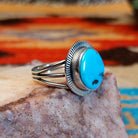 Sterling silver ring with Sleeping Beauty turquoise set in the round bezel, framed by the lined setting.