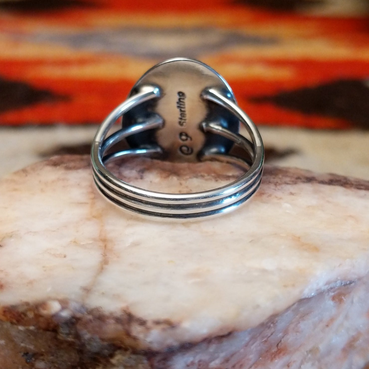 Sterling silver ring with Sleeping Beauty turquoise set in the round bezel, framed by the lined setting.