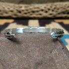 Etched silver feather cuff by Raymond Coriz, featuring a handcrafted sterling silver feather design with intricate engraved details and traditional Southwestern-inspired craftsmanship.  Underside view.