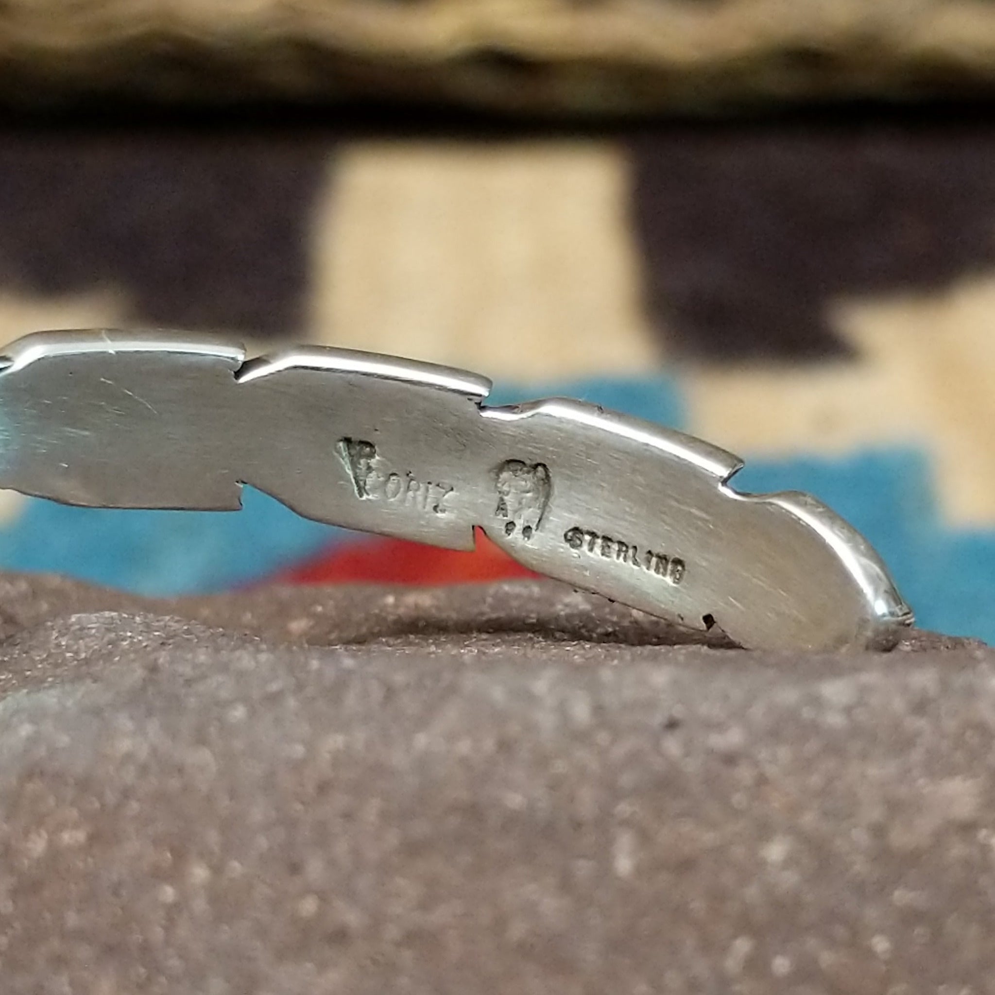 Etched silver feather cuff by Raymond Coriz, featuring a handcrafted sterling silver feather design with intricate engraved details and traditional Southwestern-inspired craftsmanship.  Artisan and Sterling Silver stamp.