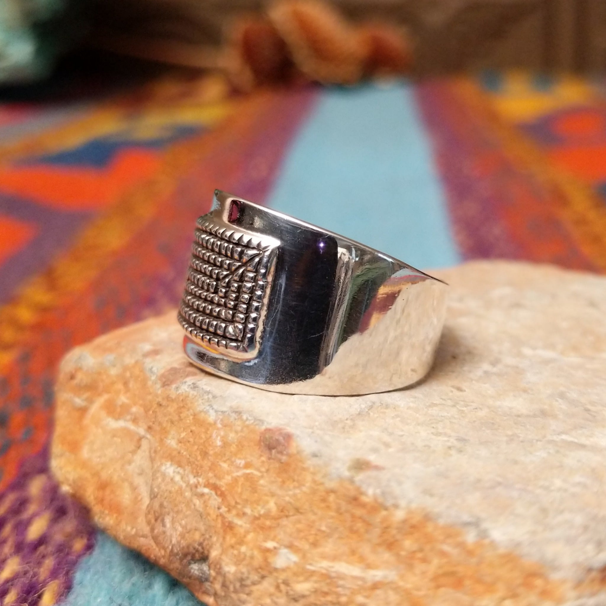 Etched Silver Ring by Raymond Coriz featuring an intricate geometric, maze-like pattern on a broad rectangular face with a polished Sterling Silver band; side view.