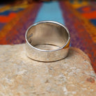 Etched Silver Ring by Raymond Coriz featuring an intricate geometric, maze-like pattern on a broad rectangular face with a polished Sterling Silver band; underside view.