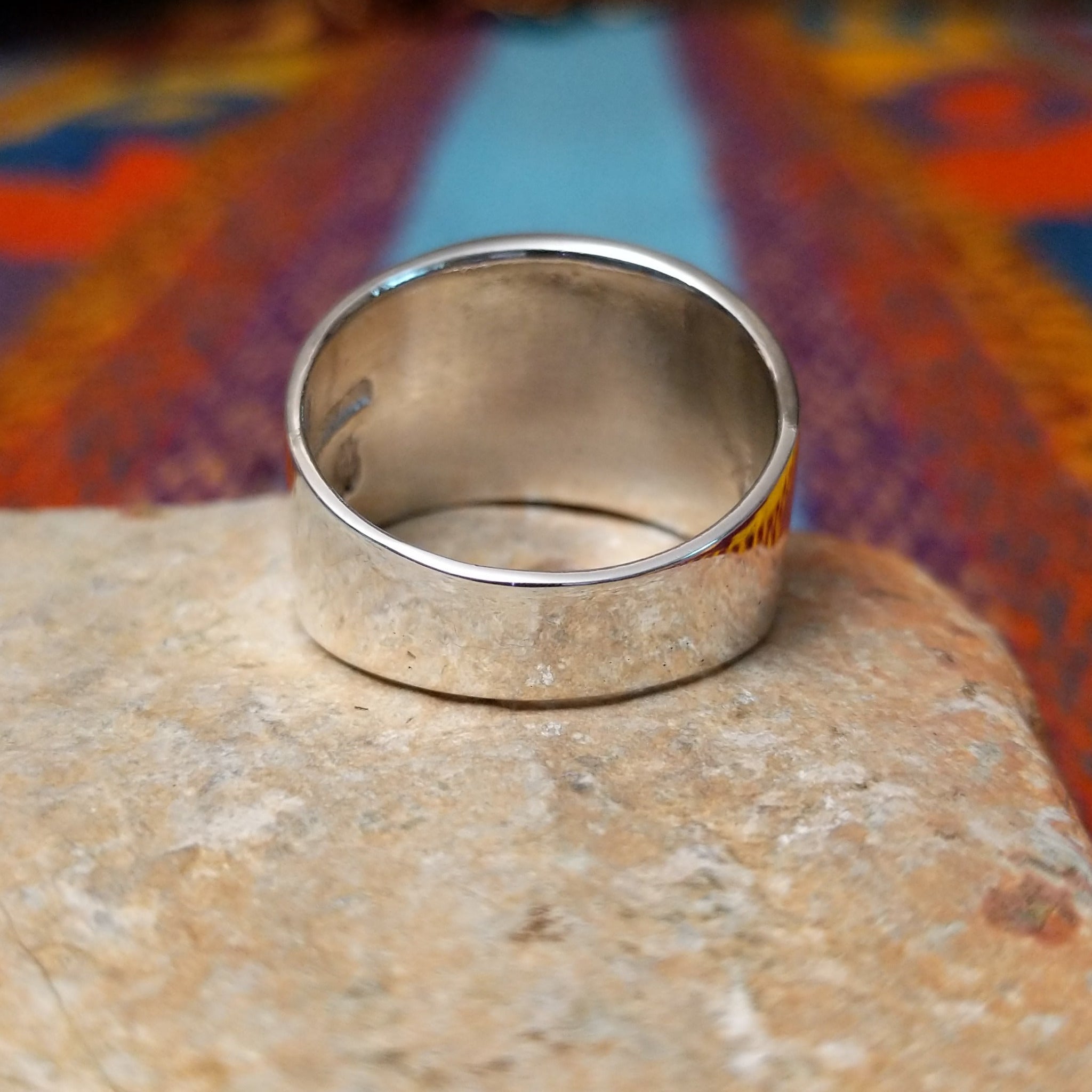 Etched Silver Ring by Raymond Coriz featuring an intricate geometric, maze-like pattern on a broad rectangular face with a polished Sterling Silver band; underside view.