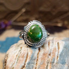 Sterling silver ring with Sonoran gold turquoise set in a round bezel, framed by twisted rope accents and an etched setting.