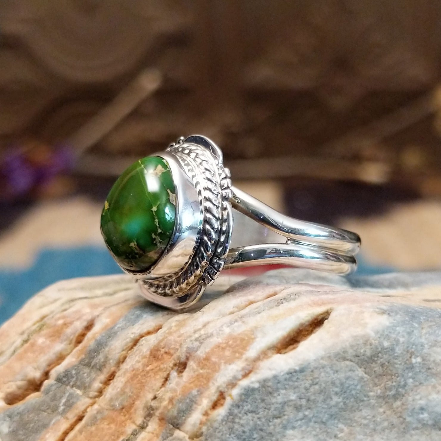 Sterling silver ring with Sonoran gold turquoise set in a round bezel, framed by twisted rope accents and an etched setting.