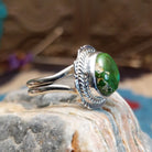 Sterling silver ring with Sonoran gold turquoise set in a round bezel, framed by twisted rope accents and an etched setting.
