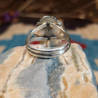 Sterling silver ring with Sonoran gold turquoise set in a round bezel, framed by twisted rope accents and an etched setting.