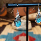 Silver-plated brass earrings with turquoise and San Pedro River sand set in teardrop bezels.