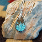 Silver-plated brass necklace with turquoise and San Pedro River sand set in the teardrop bezel.