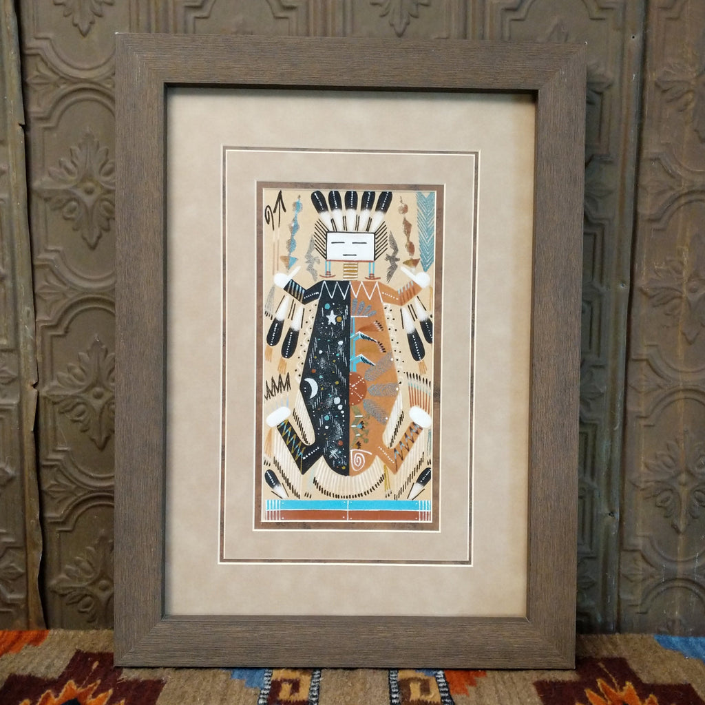 Sand used to depict Father Sky and Mother Earth in multicolored, layered sand set within a wooden frame.