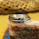 Feather loop ring by Raymond Coriz, featuring a detailed handcrafted feather design wrapped around a polished sterling silver band with traditional Southwestern-inspired craftsmanship.