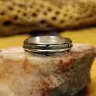 Feather loop ring by Raymond Coriz, featuring a detailed handcrafted feather design wrapped around a polished sterling silver band with traditional Southwestern-inspired craftsmanship.