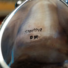 Close-up of the artisan's stamped signature.