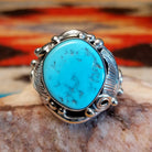 Sterling silver ring with Kingman turquoise set in the bezel, framed by unique silverwork designs.
