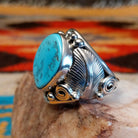 Sterling silver ring with Kingman turquoise set in the bezel, framed by unique silverwork designs.
