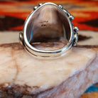 Sterling silver ring with Kingman turquoise set in the bezel, framed by unique silverwork designs.