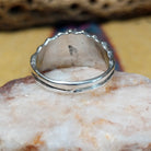 Turquoise ring with detailed sterling silver band by Raymond Coriz, featuring a vibrant blue turquoise stone with natural matrix set in a handcrafted sterling silver ring with intricate band detailing.  Underside view.