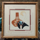 Framed Navajo sand painting of a fetish bear and pottery vessel with turquoise accents. 