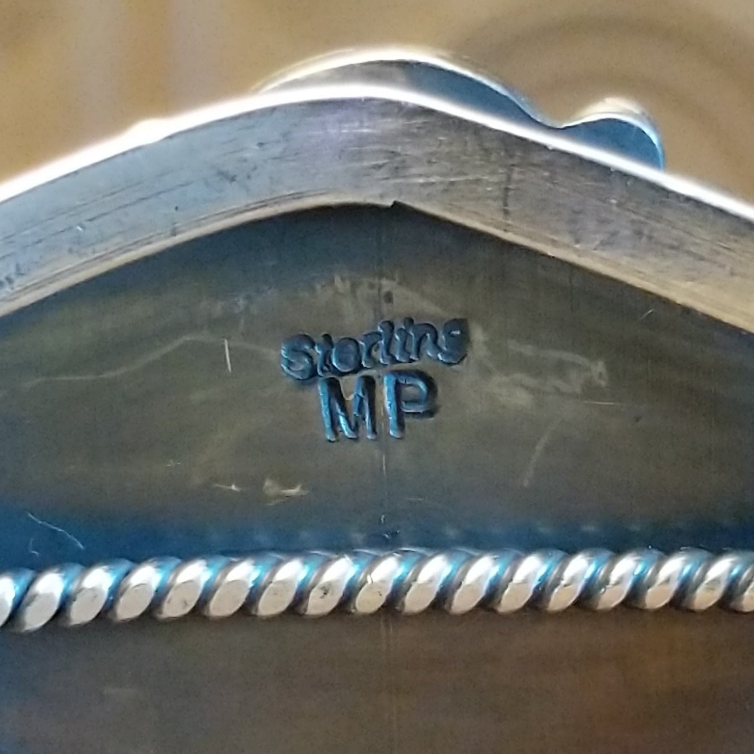 Close-up of the artisan's stamped signature.