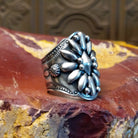 Sterling silver ring with floral detailing and dot work.