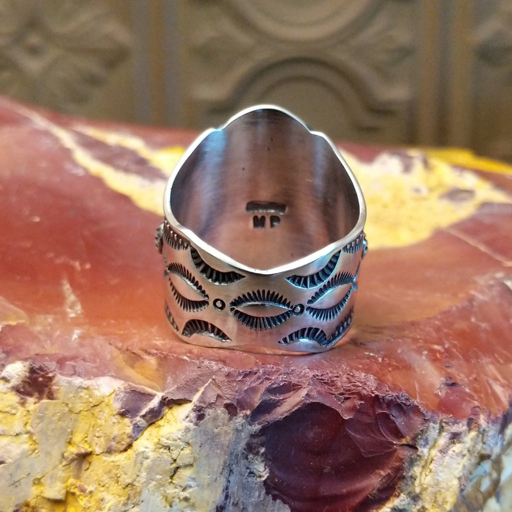 Sterling silver ring with floral detailing and dot work.