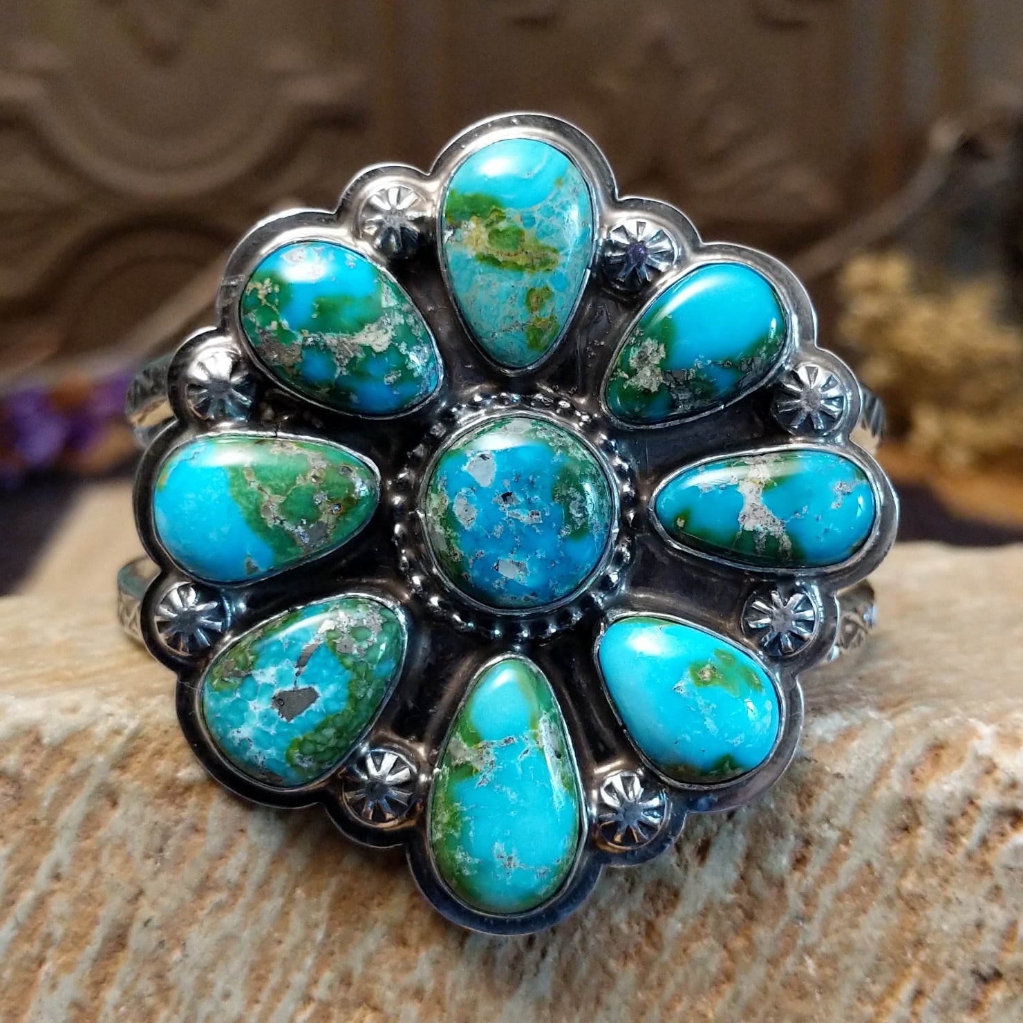 Sterling silver cuff with Sonoran gold turquoise set in bezels forming a floral design, framed by twisted rope and dotted accents.