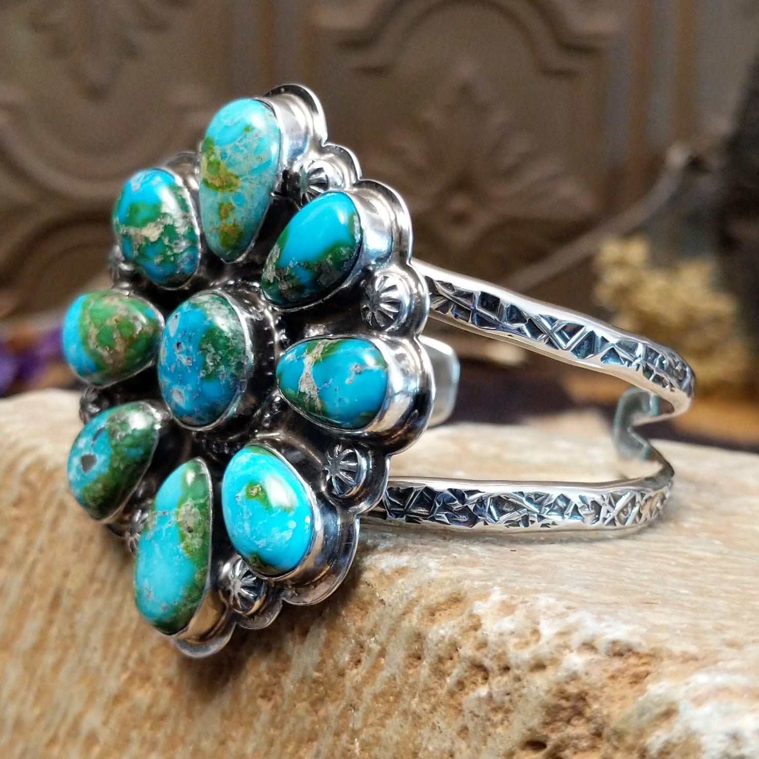 Sterling silver cuff with Sonoran gold turquoise set in bezels forming a floral design, framed by twisted rope and dotted accents.