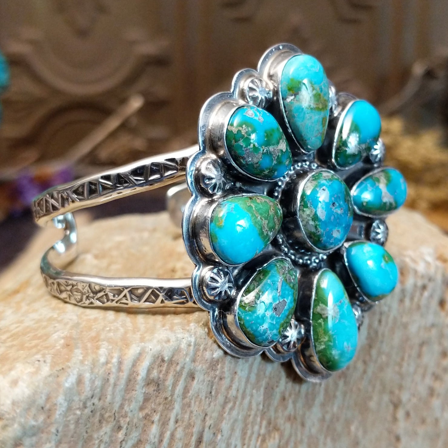Sterling silver cuff with Sonoran gold turquoise set in bezels forming a floral design, framed by twisted rope and dotted accents.