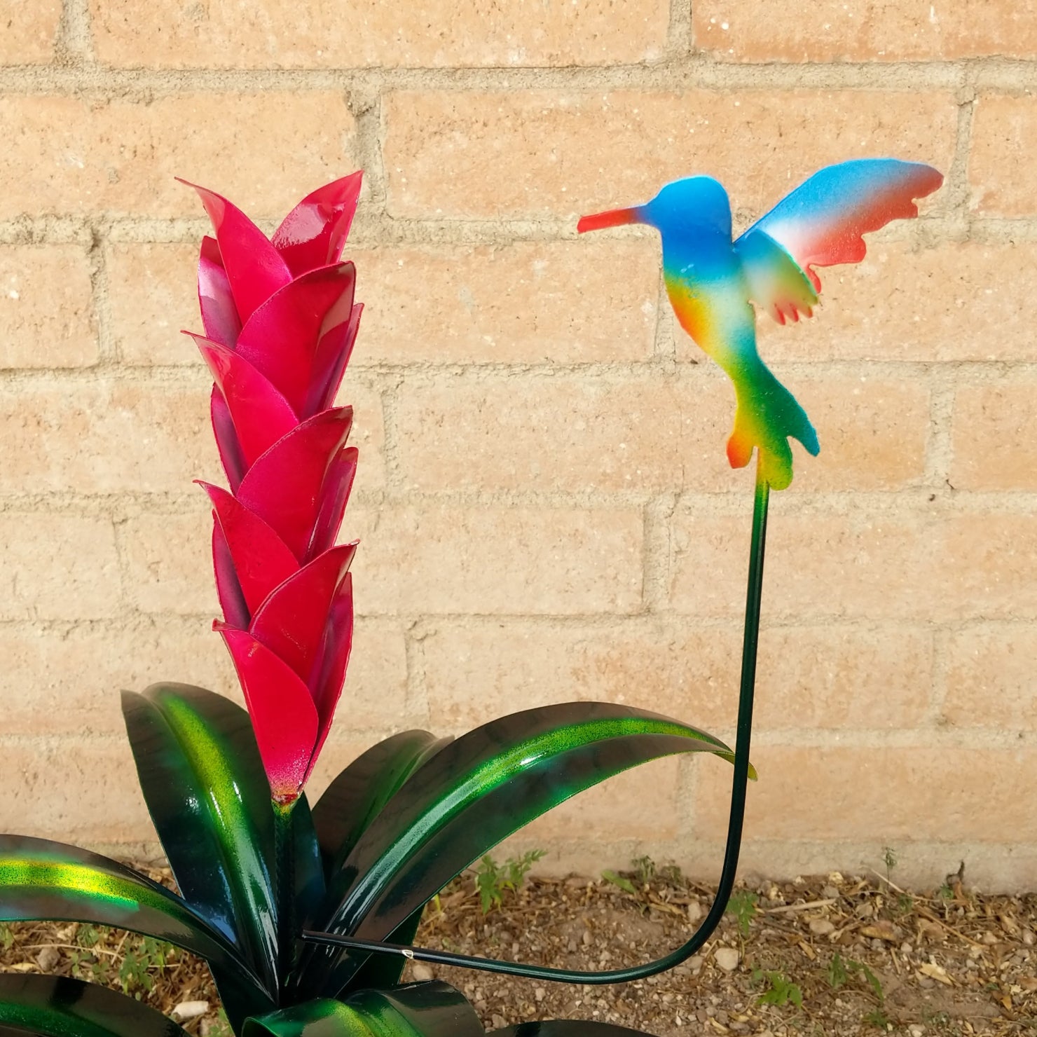 Detail of the red flower petals and multicolor hummingbird.